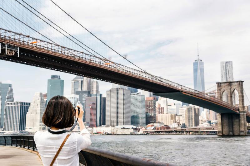 The Frederick Hotel Tribeca New York Exterior photo A tourist taking a photo of the Brooklyn Bridge